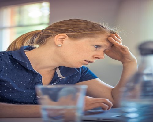 Woman working comfortably on laptop in well lit room